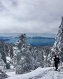 A snowshoer looks at Lake Tahoe from Chickadee Ridge